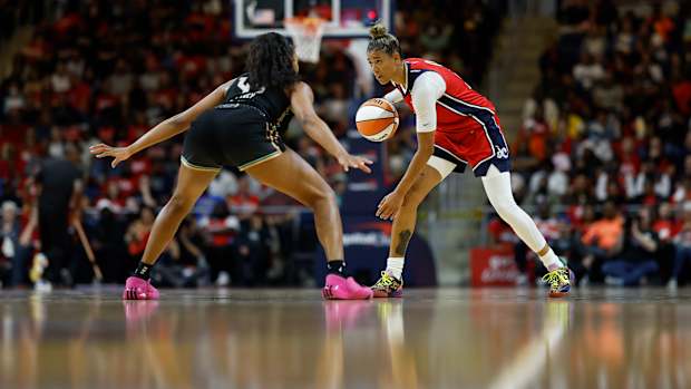 New York Liberty forward Betnijah Laney defends Washington Mystics guard Natasha Cloud.